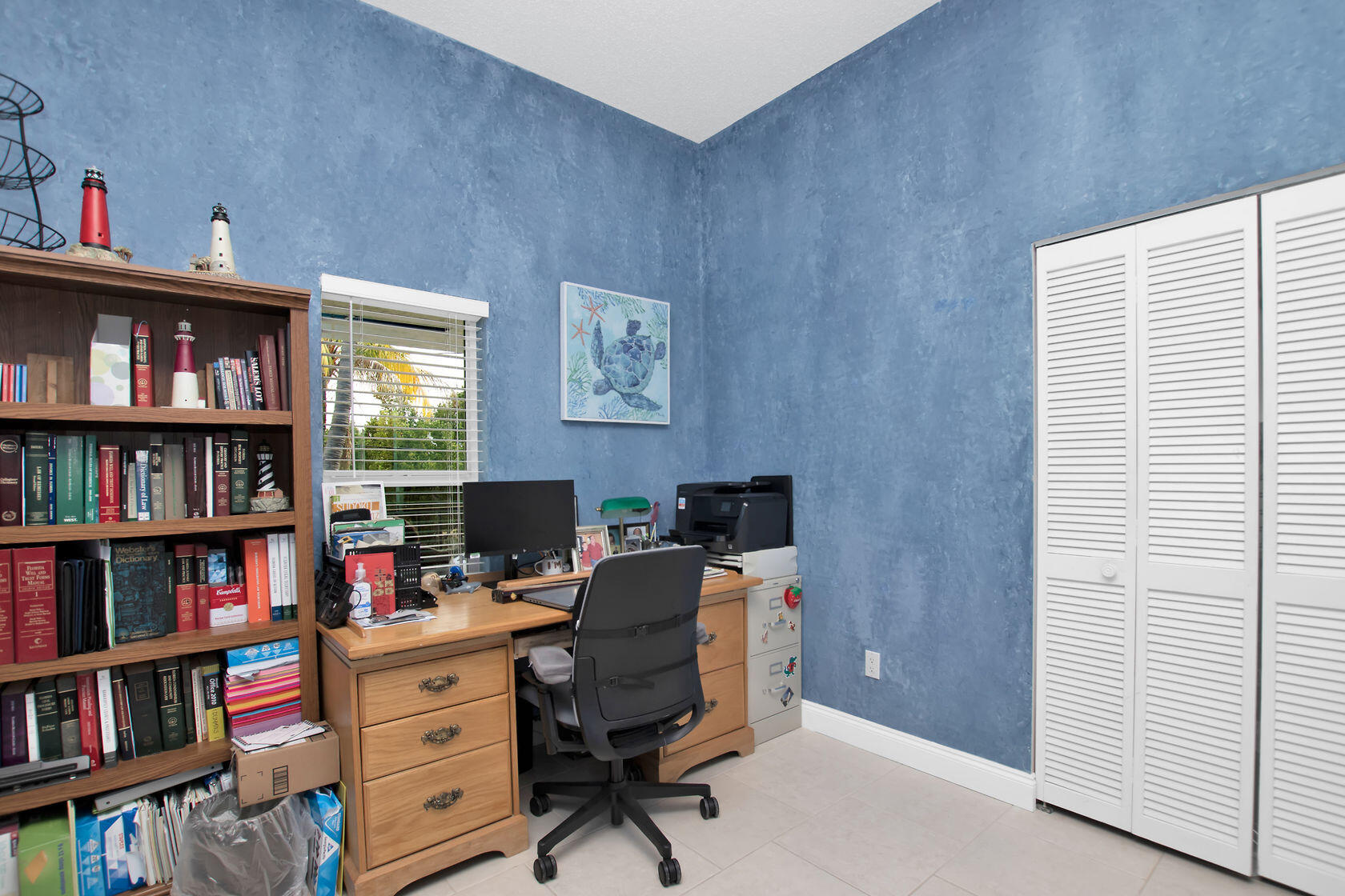 80 Seagate Boulevard Key Largo, FL 33037 - Photo 35 of 46 a view of a workspace with a bookshelf