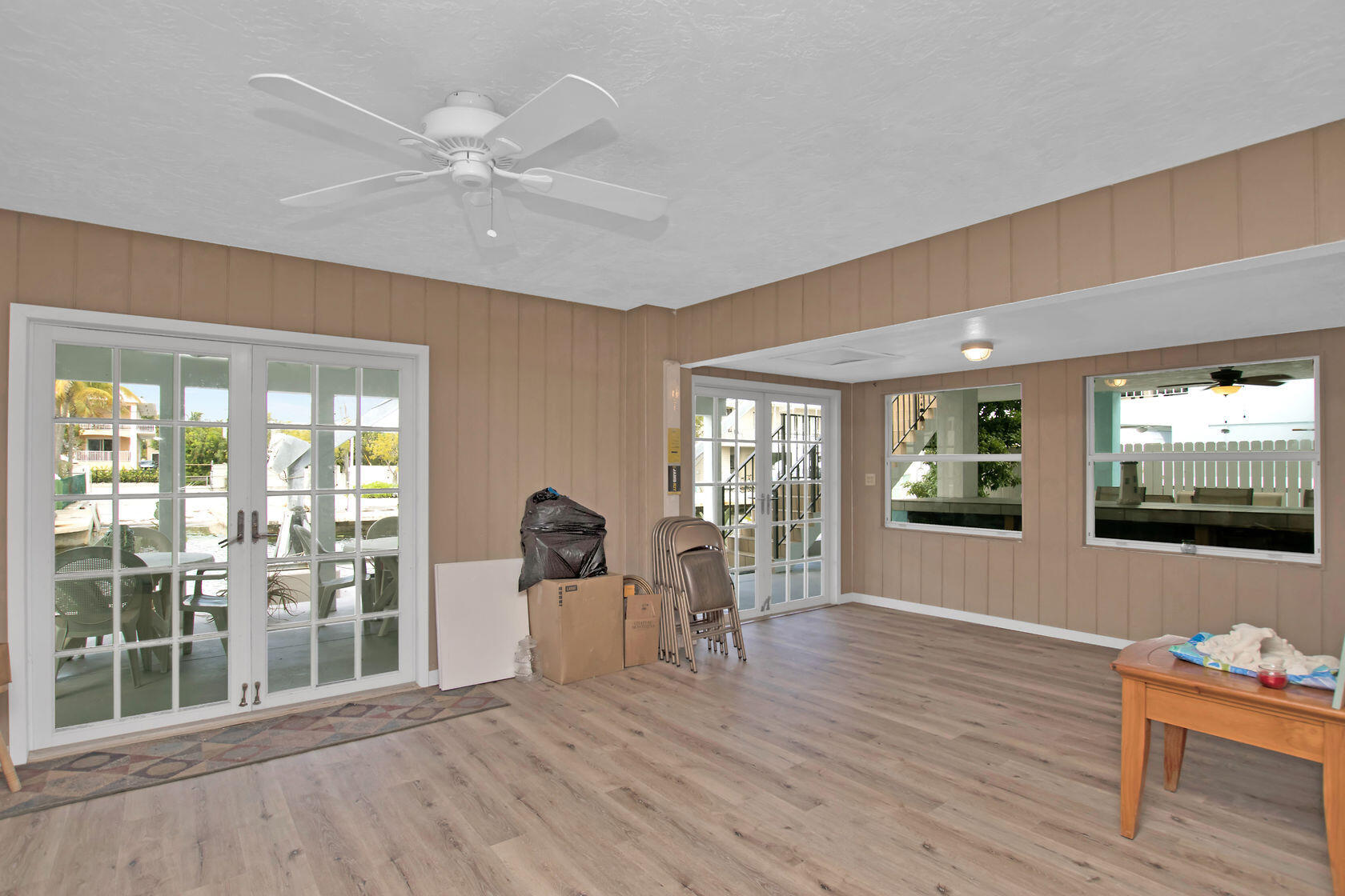 80 Seagate Boulevard Key Largo, FL 33037 - Photo 39 of 46 a view of an empty room with wooden floor and a window