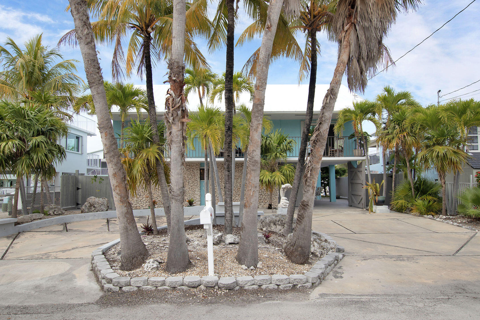 80 Seagate Boulevard Key Largo, FL 33037 - Photo 6 of 46 a palm tree sitting in front of a building
