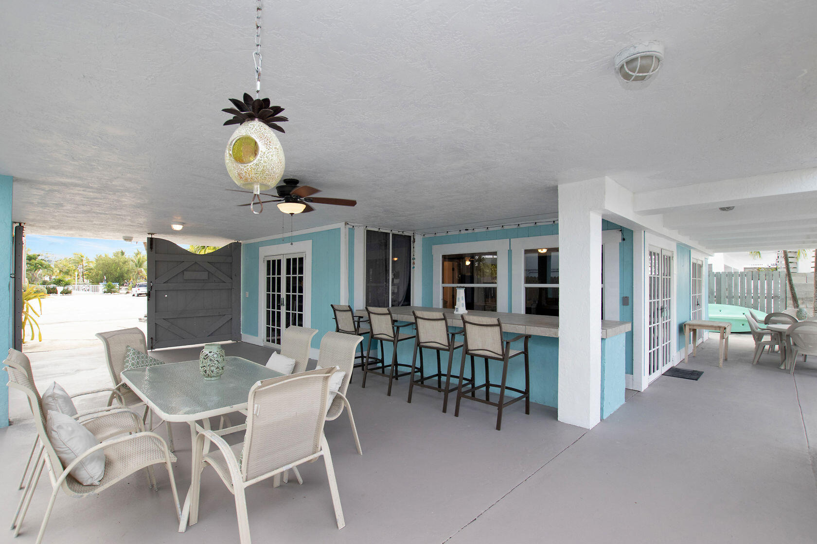 80 Seagate Boulevard Key Largo, FL 33037 - Photo 8 of 46 a view of a dining room and livingroom with furniture wooden floor and a chandelier