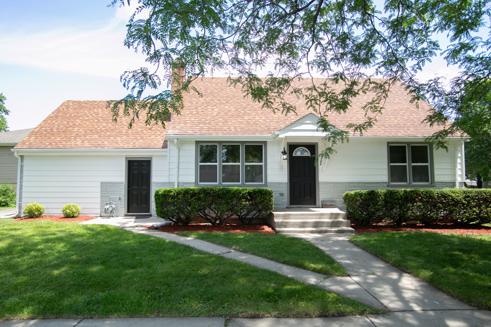 6000 Birmingham Street Chicago Ridge, IL 60415 - Photo 2 of 23 a front view of a house with a yard and garage