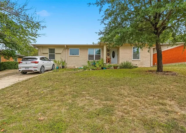 a front view of house with yard and trees