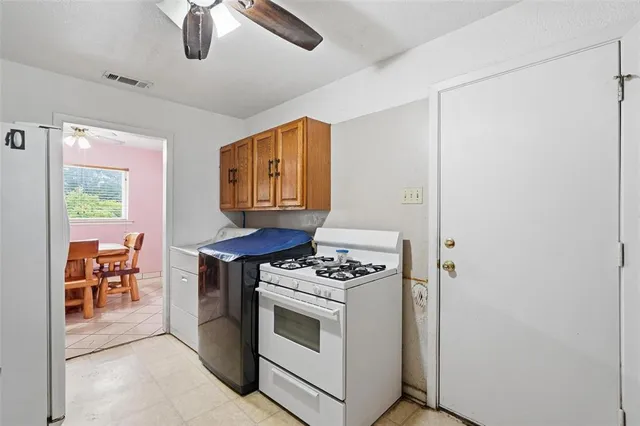 a kitchen with stainless steel appliances white cabinets and a stove