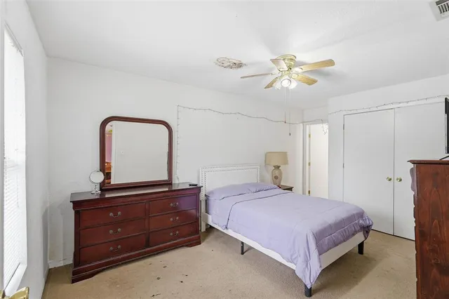 a bedroom with a bed and a dresser