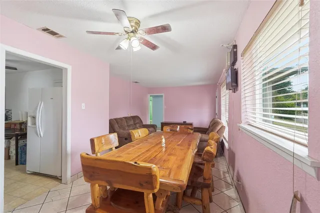 a view of a dining room with furniture and a chandelier