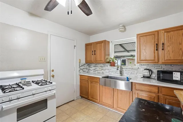 a kitchen with stainless steel appliances granite countertop a stove and a sink