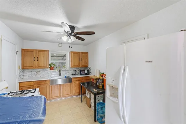 a kitchen with stainless steel appliances a stove a refrigerator and a cabinets