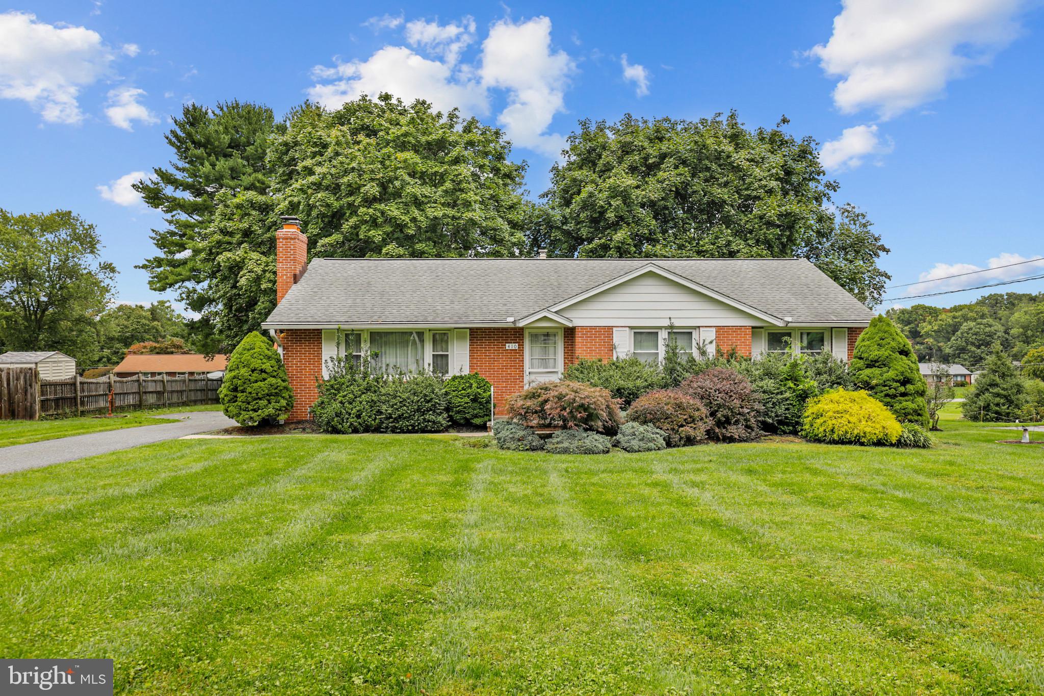 a view of a house with a yard and sitting area