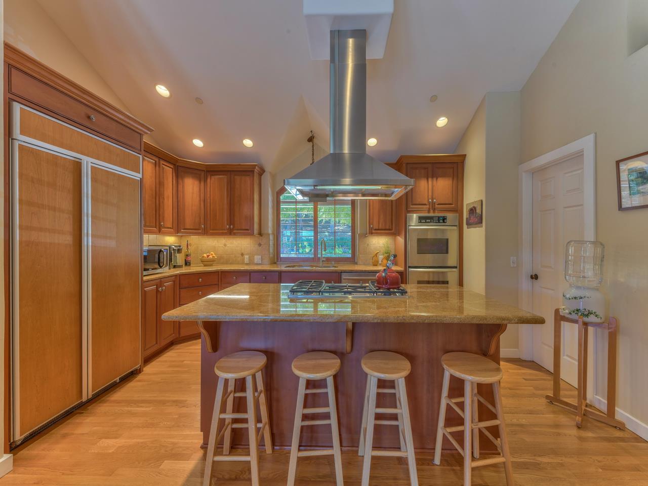 27470 Schulte Road Carmel, CA 93923 - Photo 12 of 56 a kitchen with granite countertop kitchen island stainless steel appliances a sink and a refrigerator
