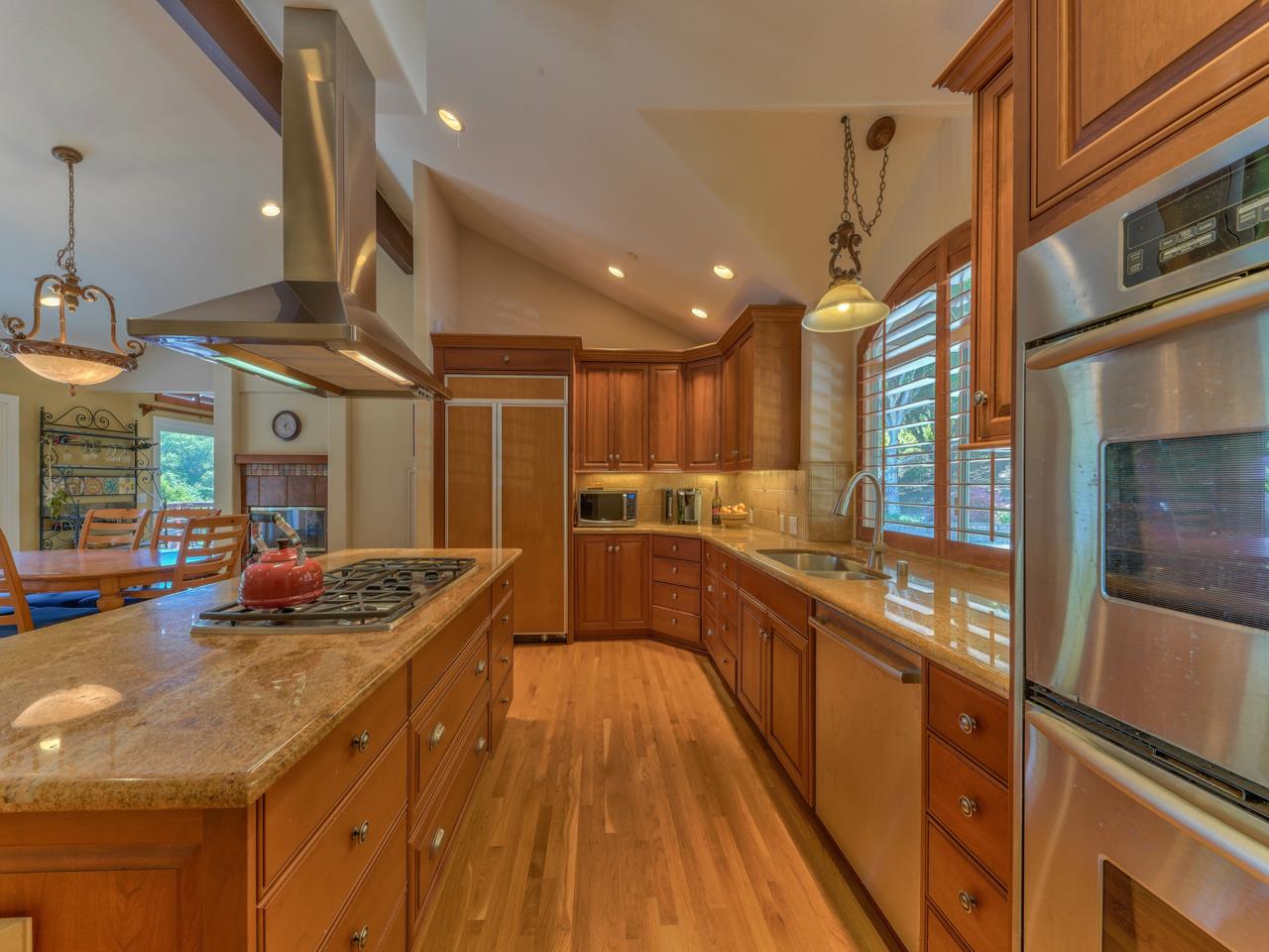 27470 Schulte Road Carmel, CA 93923 - Photo 13 of 56 a kitchen with stainless steel appliances granite countertop a sink a stove and a wooden floors