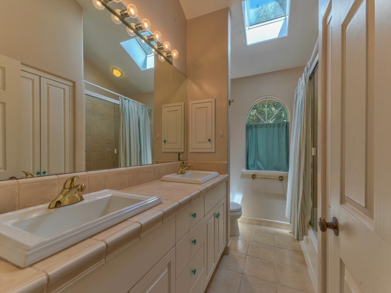 27470 Schulte Road Carmel, CA 93923 - Photo 35 of 56 a bathroom with a sink double vanity and a mirror