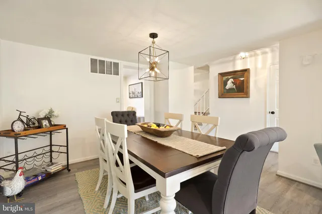 a view of a dining room with furniture and a chandelier