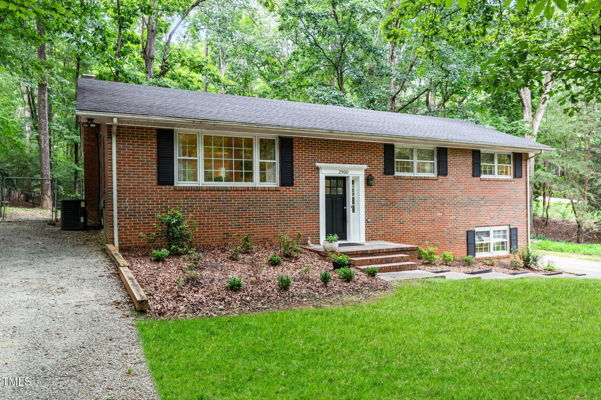 2900 Beechgrove Drive Durham, NC 27705 - Photo 1 of 32 a front view of a house with garden