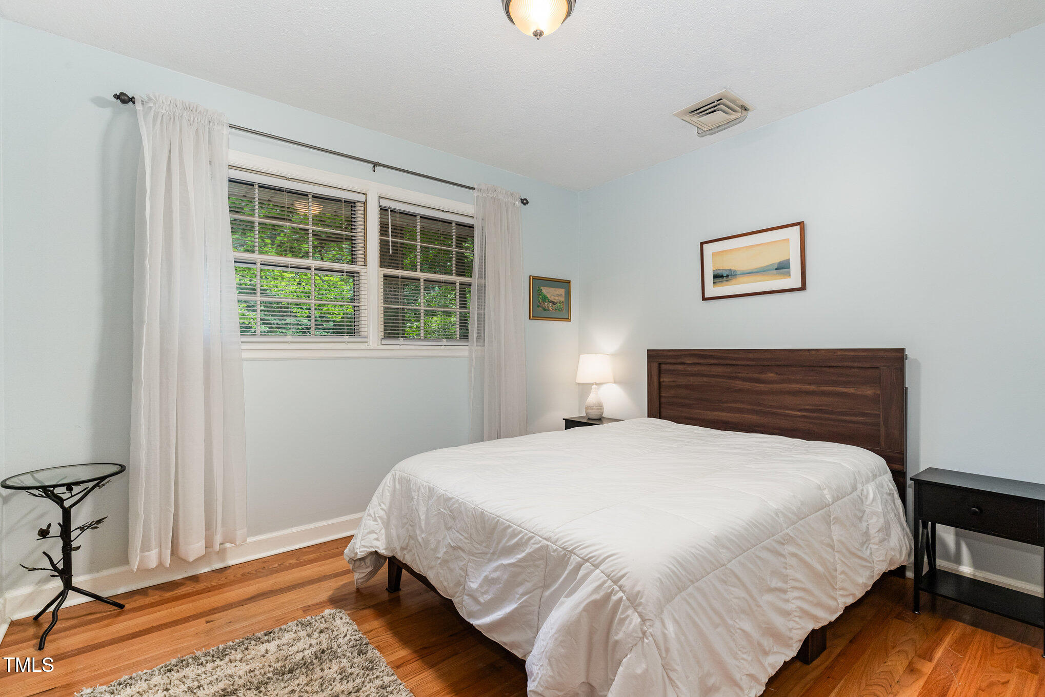 2900 Beechgrove Drive Durham, NC 27705 - Photo 15 of 32 a bedroom with a bed and a window
