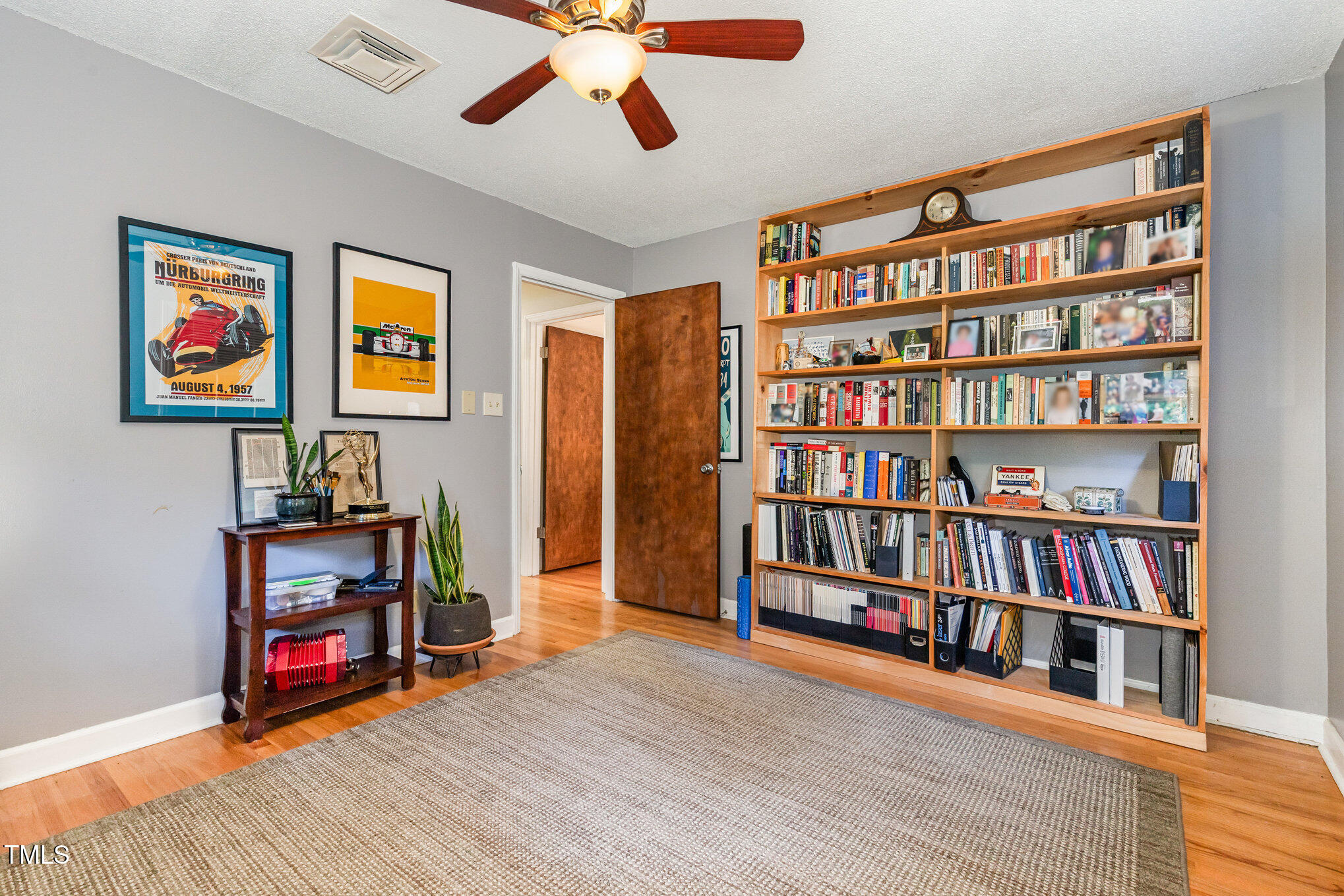 2900 Beechgrove Drive Durham, NC 27705 - Photo 18 of 32 a room with furniture and a book shelf