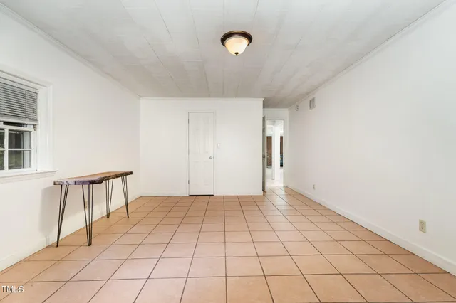 a view of kitchen with furniture and refrigerator