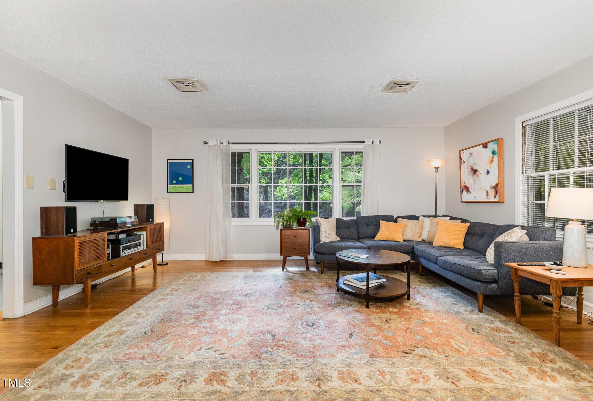 2900 Beechgrove Drive Durham, NC 27705 - Photo 8 of 32 a living room with furniture and a flat screen tv