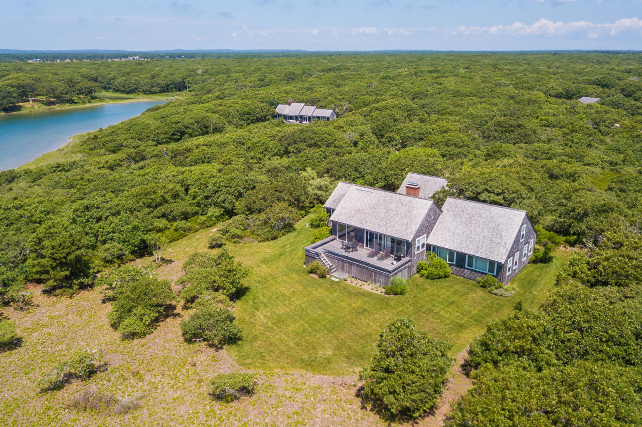 50 Oyster Watcha Road Edgartown, MA 02539 - Photo 7 of 27 a swimming pool with some trees in the background
