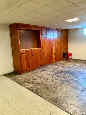 a room with water heater and wooden floor