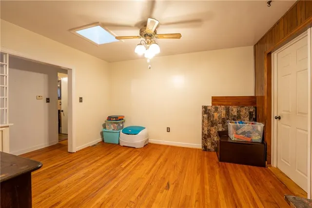 a bedroom with a bed and a wooden floor