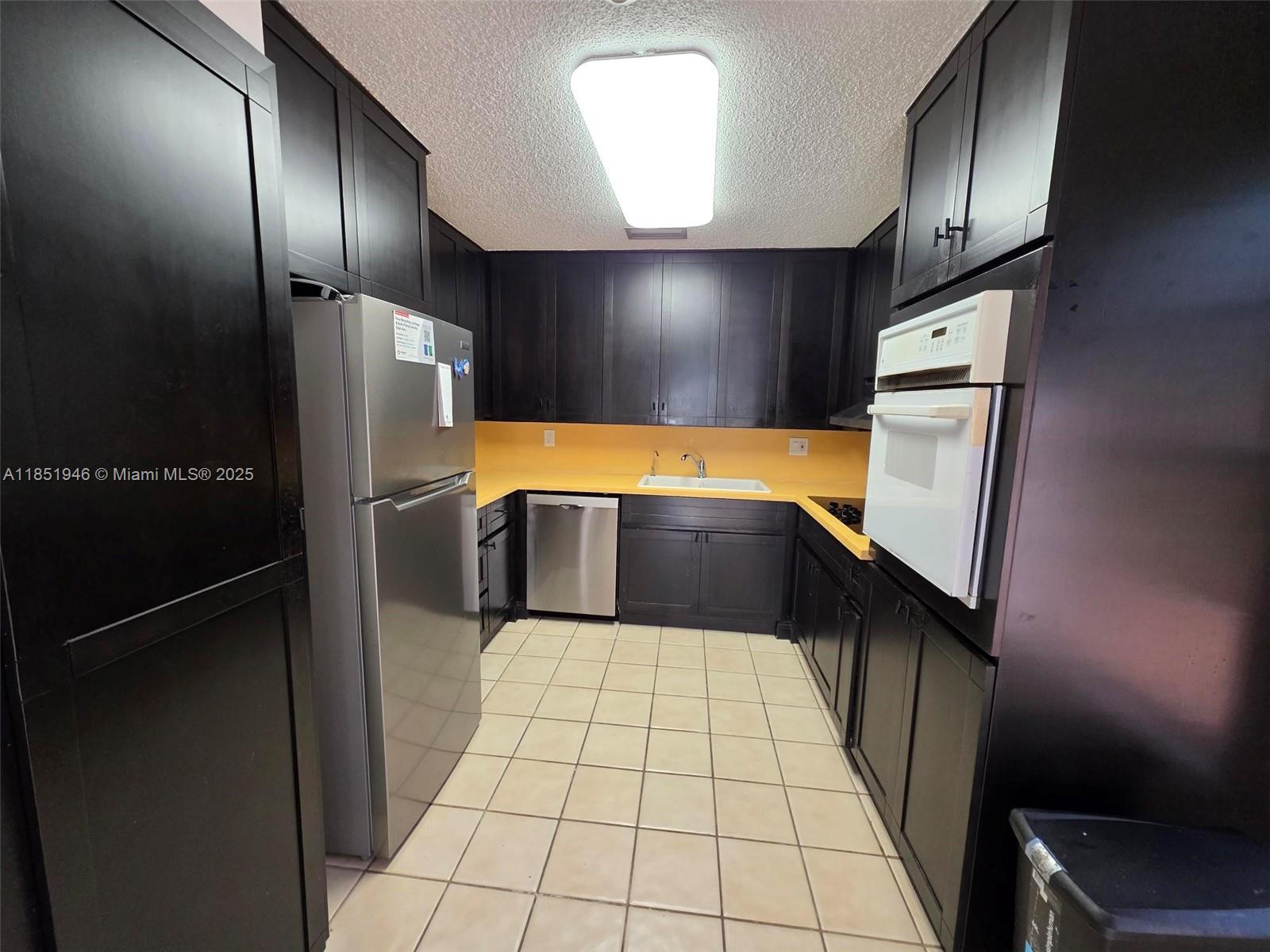 2320 Dover, Unit 2320 Weston, FL 33326 - Photo 11 of 44 a kitchen with stainless steel appliances a refrigerator and a sink