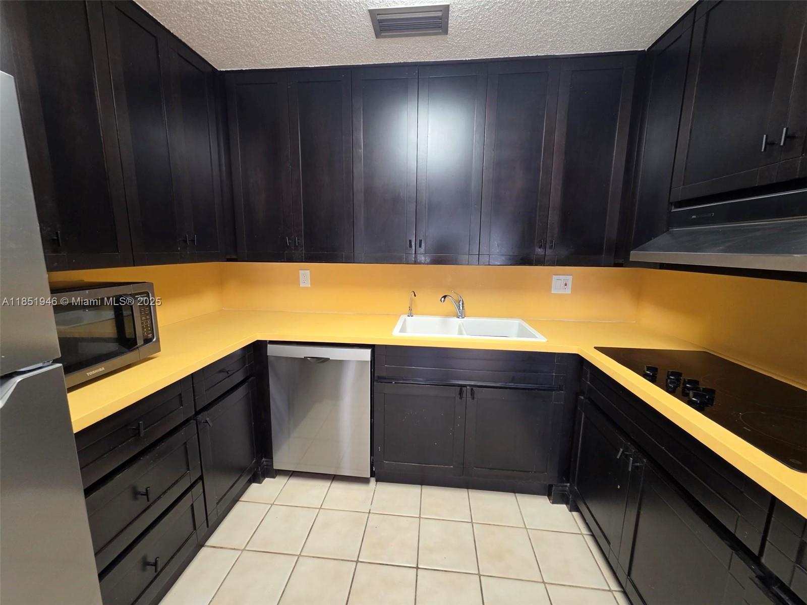 2320 Dover, Unit 2320 Weston, FL 33326 - Photo 13 of 44 a kitchen with a sink and cabinets
