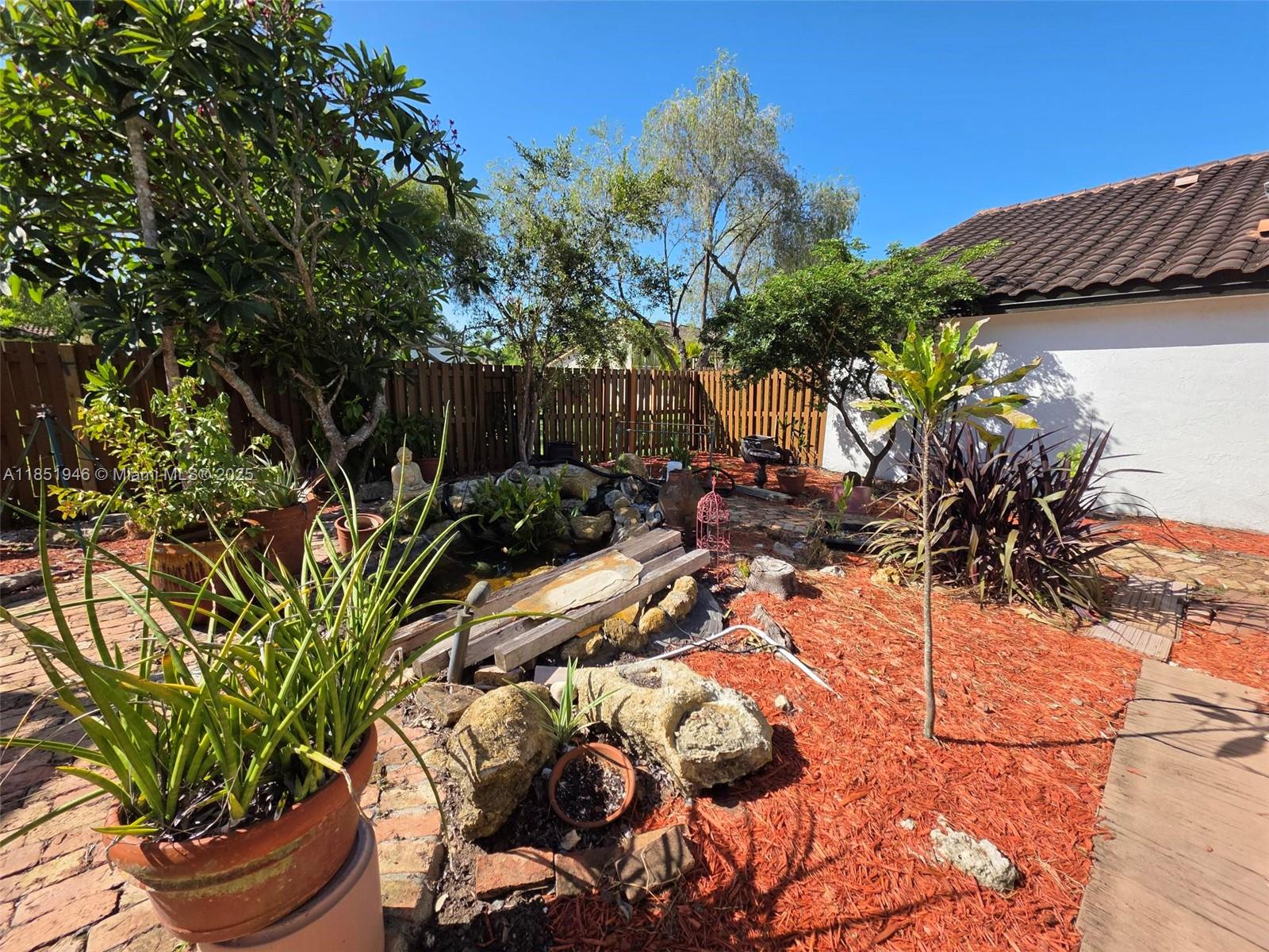 2320 Dover, Unit 2320 Weston, FL 33326 - Photo 19 of 44 a view of backyard with plants and outdoor seating
