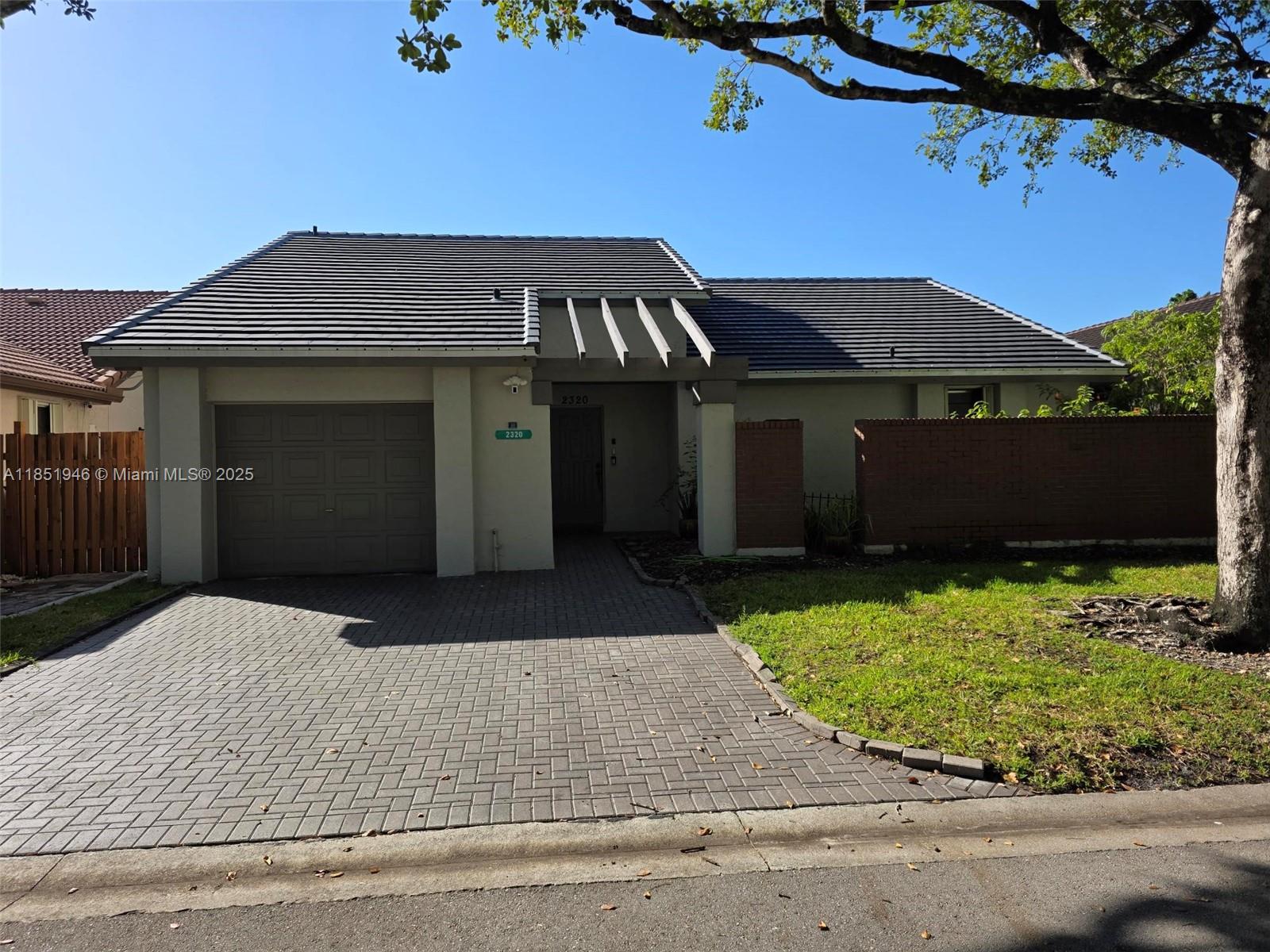 2320 Dover, Unit 2320 Weston, FL 33326 - Photo 2 of 44 front view of a house with a yard