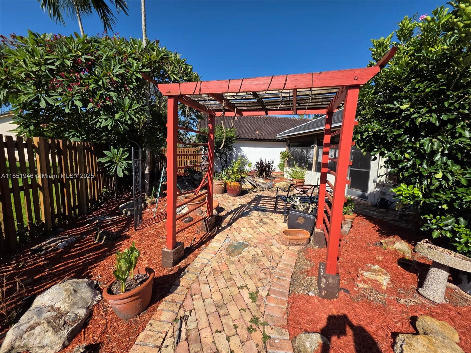2320 Dover, Unit 2320 Weston, FL 33326 - Photo 24 of 44 a view of a patio with table and chairs potted plants and large tree