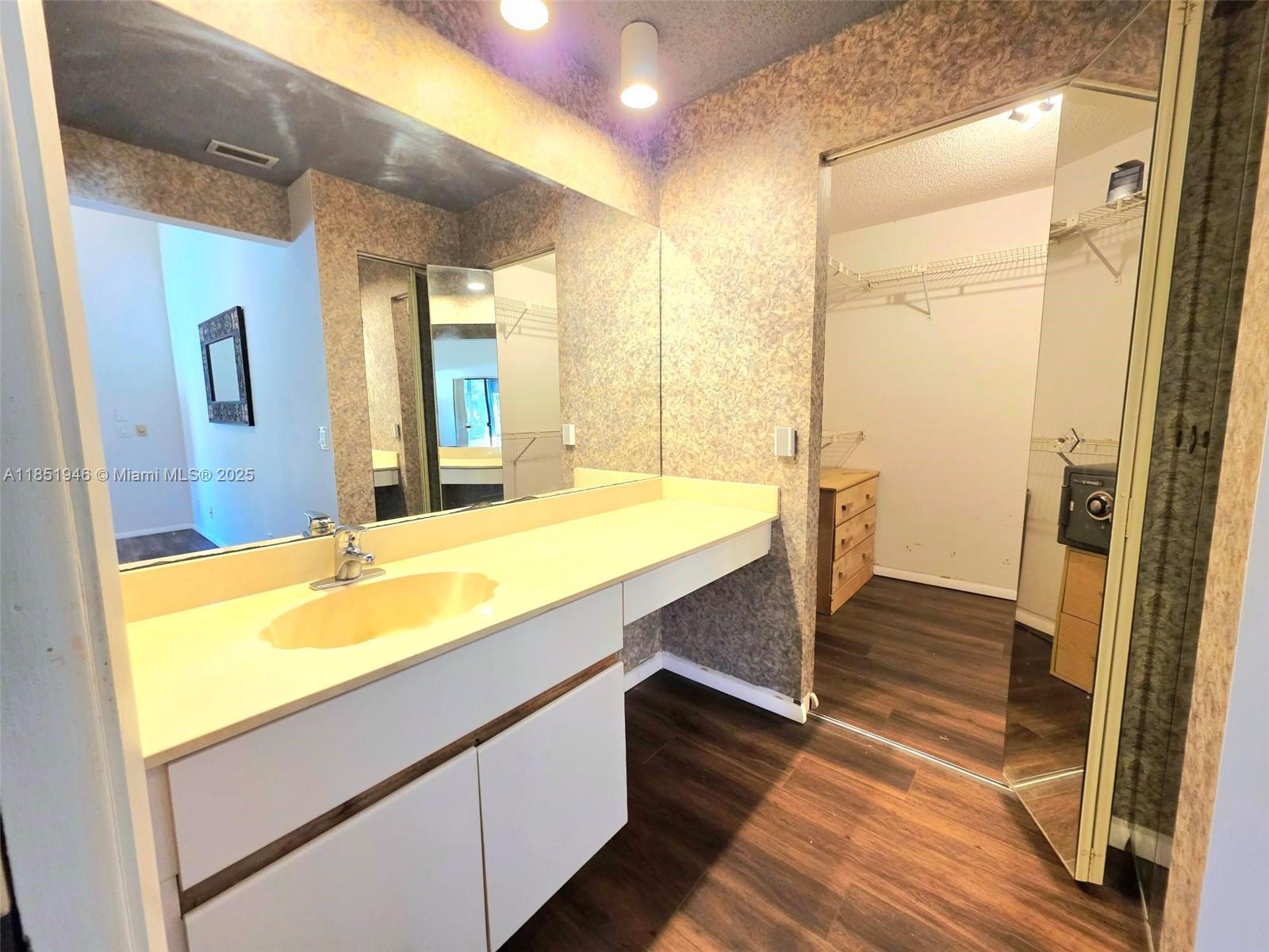 2320 Dover, Unit 2320 Weston, FL 33326 - Photo 30 of 44 a bathroom with a sink and a large mirror