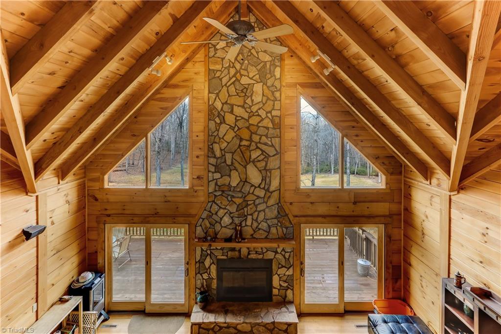 8605 Tuttle Ridge Road Germanton, NC 27019 - Photo 2 of 30 Enjoy the view from the great room or the loft above. The stone fireplace extends the full height of the great room. There is no shortage of beautiful scenery and craftsmanship in this home.