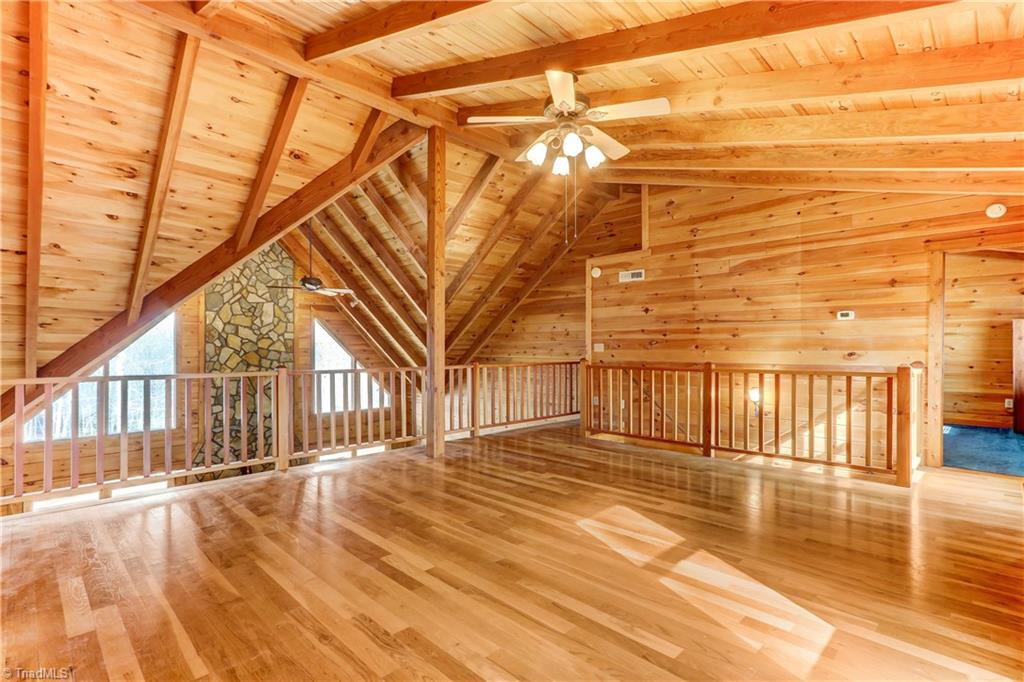 8605 Tuttle Ridge Road Germanton, NC 27019 - Photo 11 of 30 The lofted area above the great room maximizes the beauty of the floor to ceiling windows. Use this space to meet your needs. It would be perfect for a study, sitting area,home office or yoga studio.