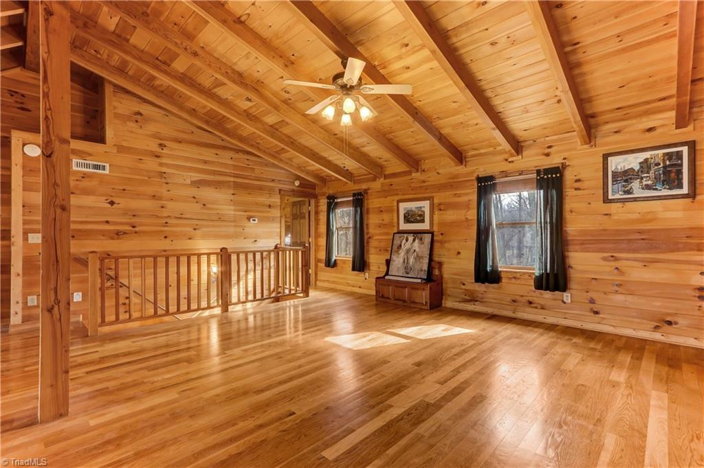 8605 Tuttle Ridge Road Germanton, NC 27019 - Photo 12 of 30 Another view of the loft shows the windows on the front of the house and the vaulted ceiling. Notice the internal vacuum system at the top of the stairs, making maintenance of the beautiful wood floors a breeze!