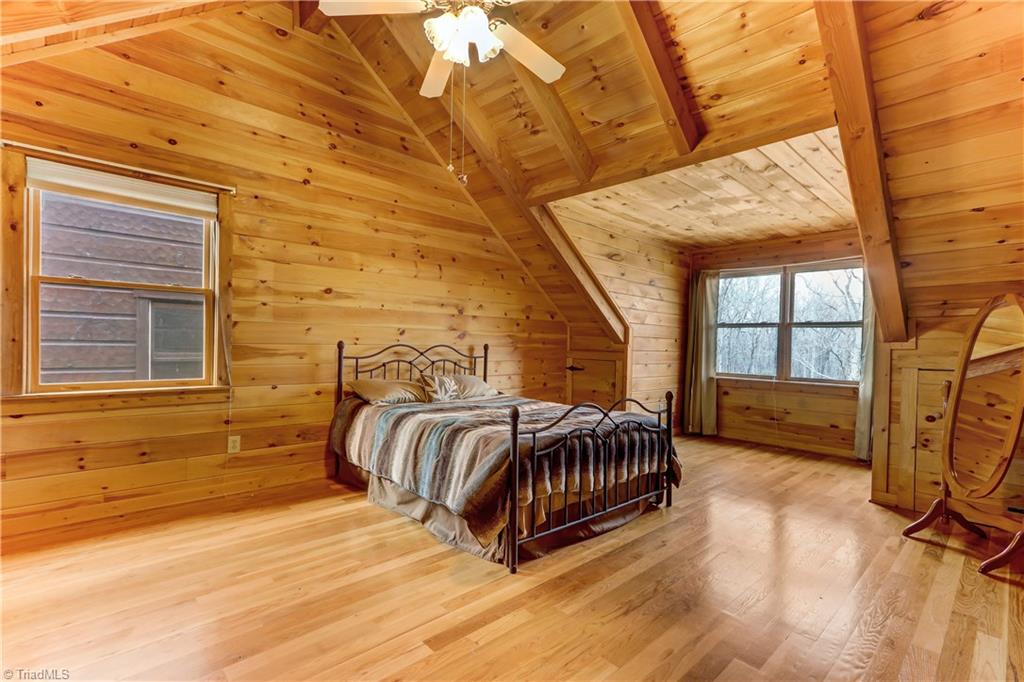 8605 Tuttle Ridge Road Germanton, NC 27019 - Photo 13 of 30 The bedroom on the second level has beautiful detail like vaulted ceilings and a dormer window.