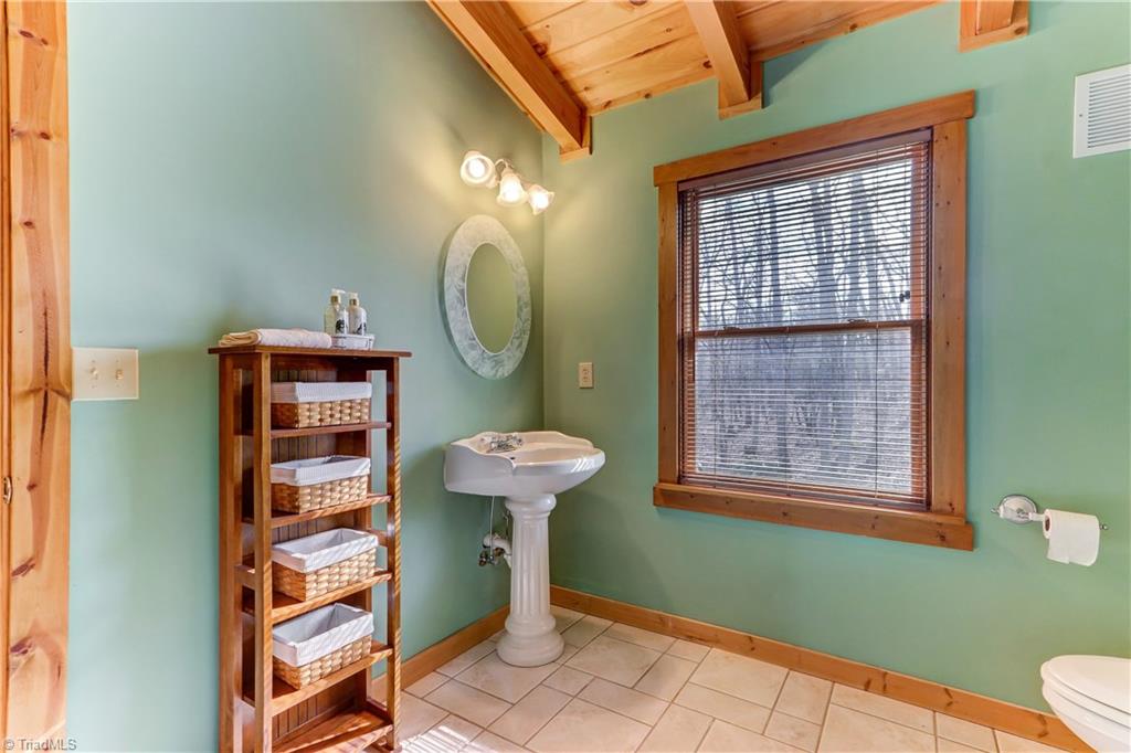 8605 Tuttle Ridge Road Germanton, NC 27019 - Photo 14 of 30 The bathroom on the second level has ceramic tile floor and a claw foot tub for added charm!