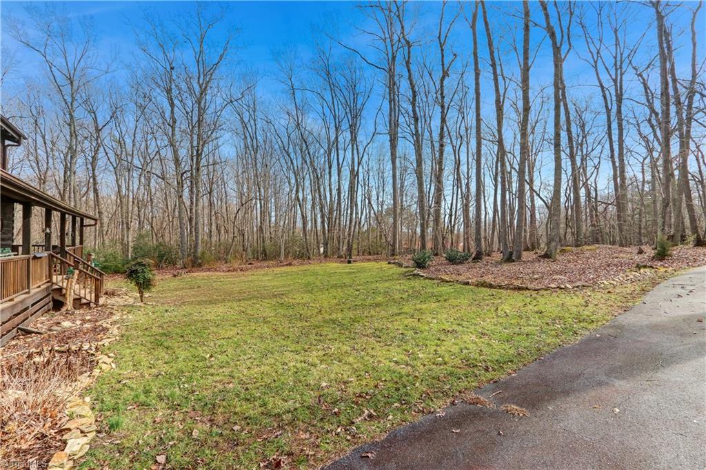8605 Tuttle Ridge Road Germanton, NC 27019 - Photo 19 of 30 The front yard is bordered by natural landscaping and wooded areas.