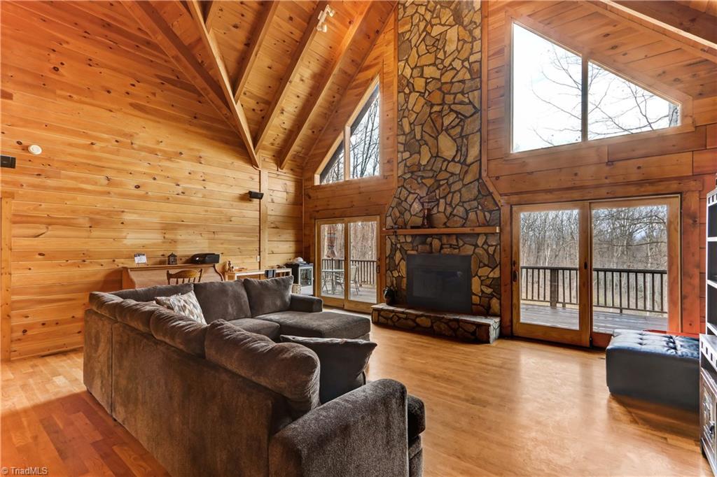 8605 Tuttle Ridge Road Germanton, NC 27019 - Photo 3 of 30 Relax in this spacious great room and enjoy the natural beauty that surrounds. Hardwood floors continue throughout the home.