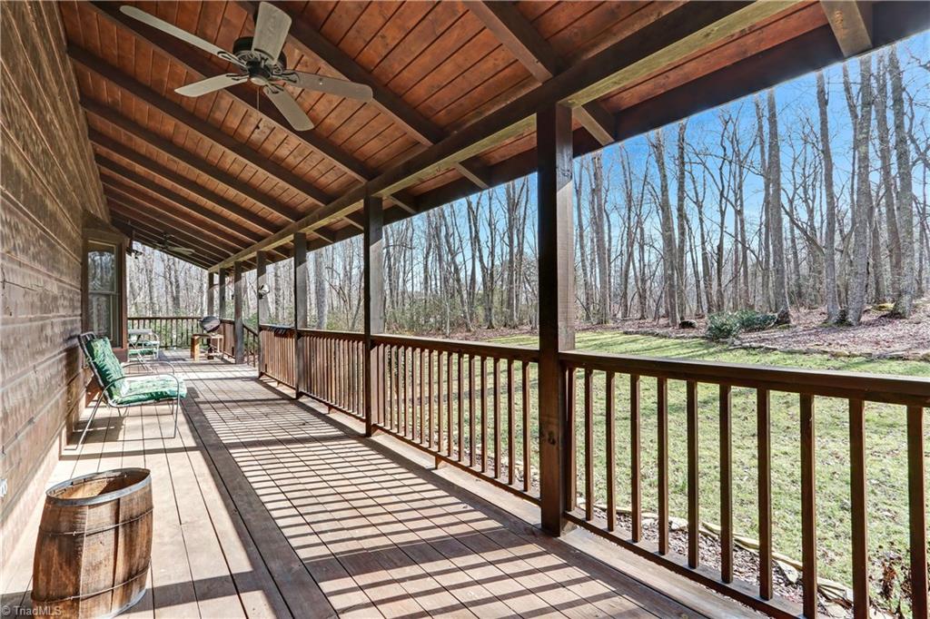 8605 Tuttle Ridge Road Germanton, NC 27019 - Photo 20 of 30 The long front porch with two ceiling fans is the perfect place to relax and take in the views. Warm breezes, trees swaying in the wind...perfection.