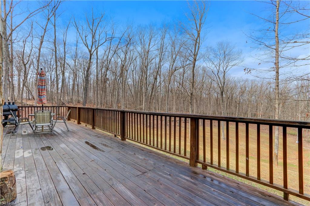 8605 Tuttle Ridge Road Germanton, NC 27019 - Photo 21 of 30 The deck boasts sweeping views of the partially cleared lot. Any season is beautiful from this vantage point.