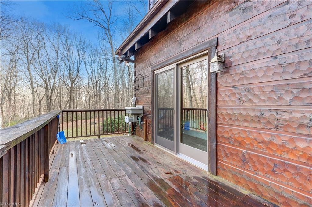 8605 Tuttle Ridge Road Germanton, NC 27019 - Photo 22 of 30 Sliding glass doors lead to the great room. Grill out or relax on this spacious deck.