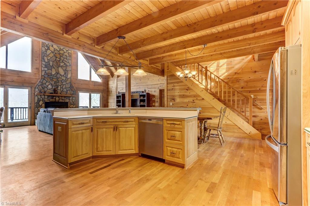 8605 Tuttle Ridge Road Germanton, NC 27019 - Photo 4 of 30 The center kitchen console overlooks the great room and floor to ceiling windows. If you have to dishes, you might as well have a beautiful view!