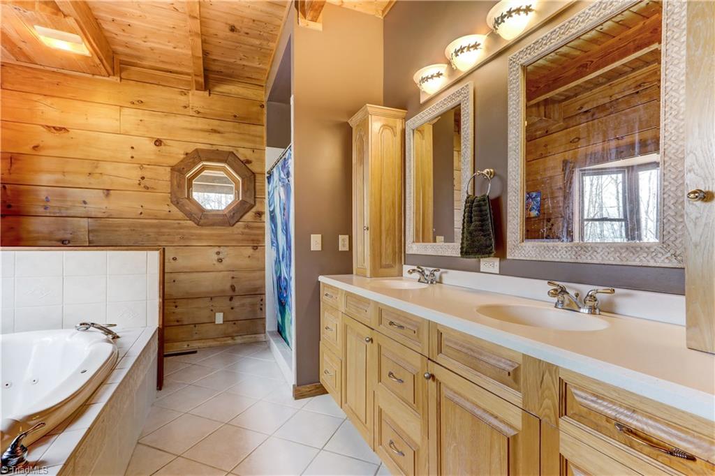 8605 Tuttle Ridge Road Germanton, NC 27019 - Photo 9 of 30 The master bath has ceramic tile floors and tub surround, separate shower, double sinks and additional built in storage.