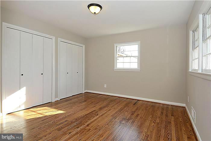 10618 Glenwild Road Silver Spring, MD 20901 - Photo 14 of 19 an empty room with wooden floor and windows