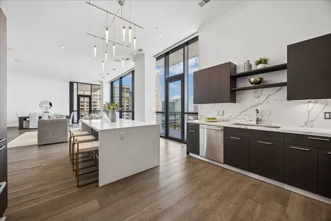 a kitchen with stainless steel appliances a sink and stove top oven
