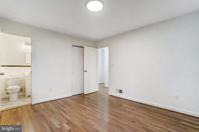 a view of a room with wooden floor and a sink