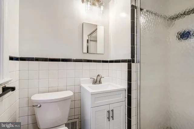 a bathroom with a toilet sink and mirror