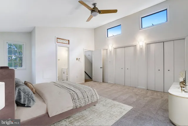 a spacious bedroom with a bed and a chandelier
