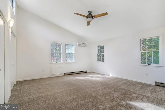a view of a livingroom with a ceiling fan and window