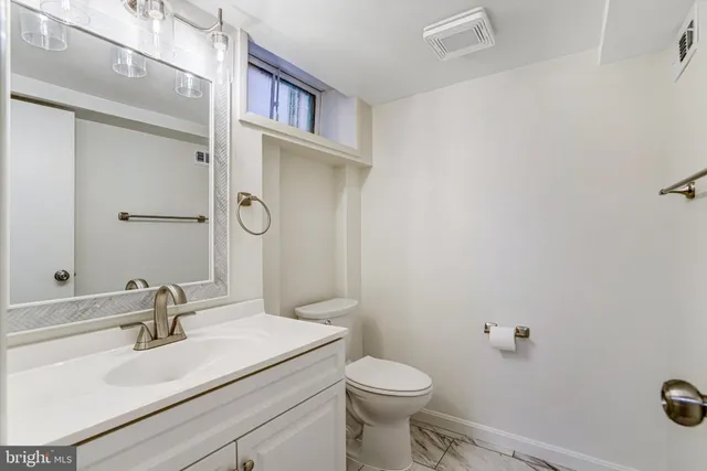 a bathroom with a sink toilet and vanity