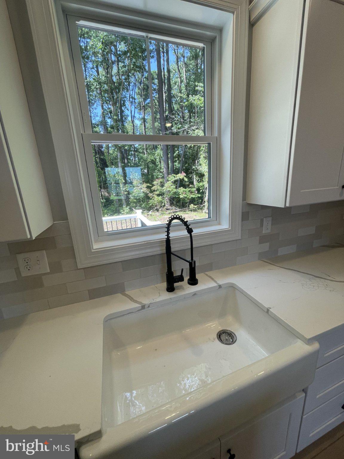 506 Talbot Road Stevensville, MD 21666 - Photo 9 of 30 Large farmhouse sink overlooks deck and yard.